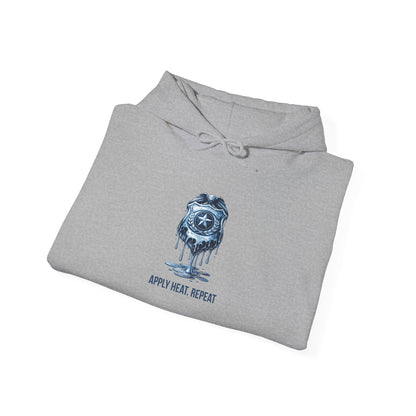 Apply Heat Repeat anti-ICE hoodie by Moral Fabric — melting badge graphic on progressive political streetwear