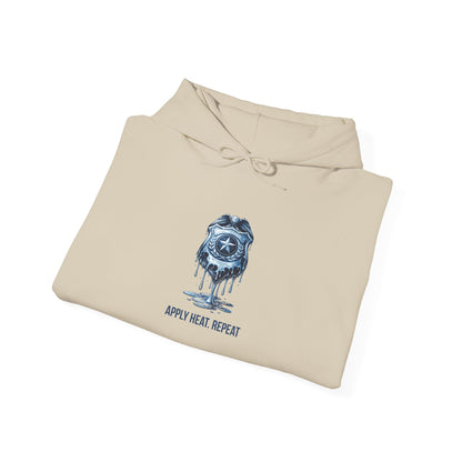 Apply Heat Repeat anti-ICE hoodie by Moral Fabric — melting badge graphic on progressive political streetwear