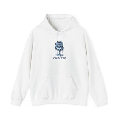 Apply Heat Repeat anti-ICE hoodie by Moral Fabric — melting badge graphic on progressive political streetwear
