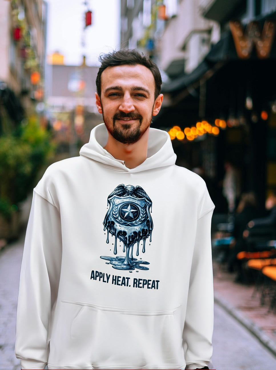 Apply Heat Repeat anti-ICE hoodie by Moral Fabric — melting badge graphic on progressive political streetwear