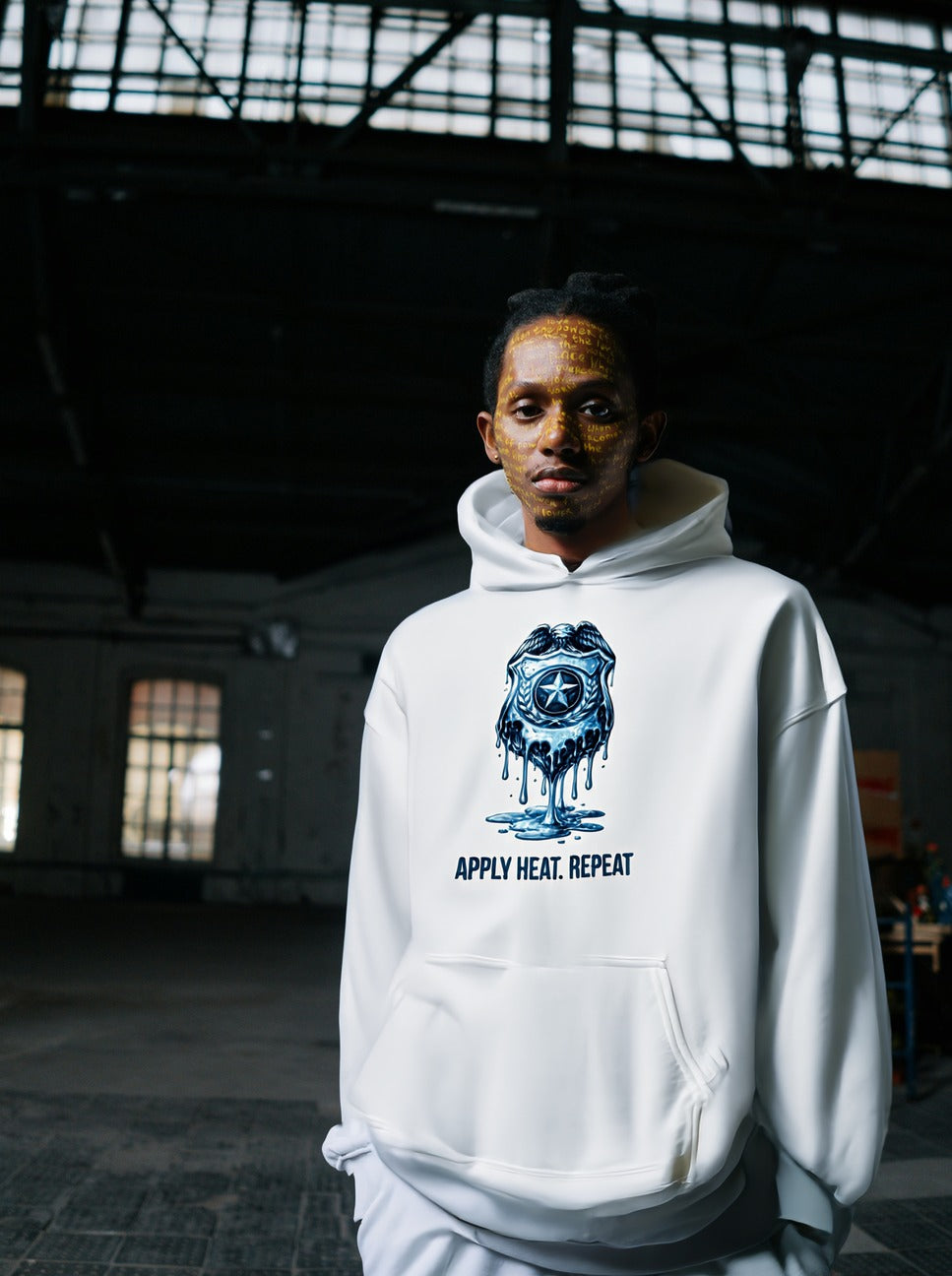 Apply Heat Repeat anti-ICE hoodie by Moral Fabric — melting badge graphic on progressive political streetwear